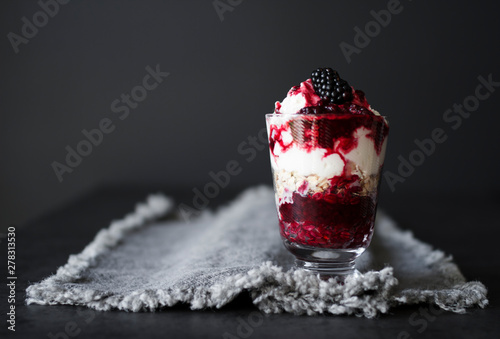 Vanilla cream with blackberry sauce and oats photo