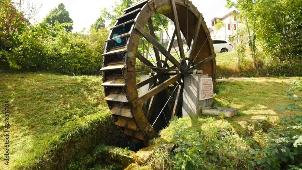 Large wooden water wheel turning quickly. Long zoom in Large wooden water wheel turning quickly. Long zoom in