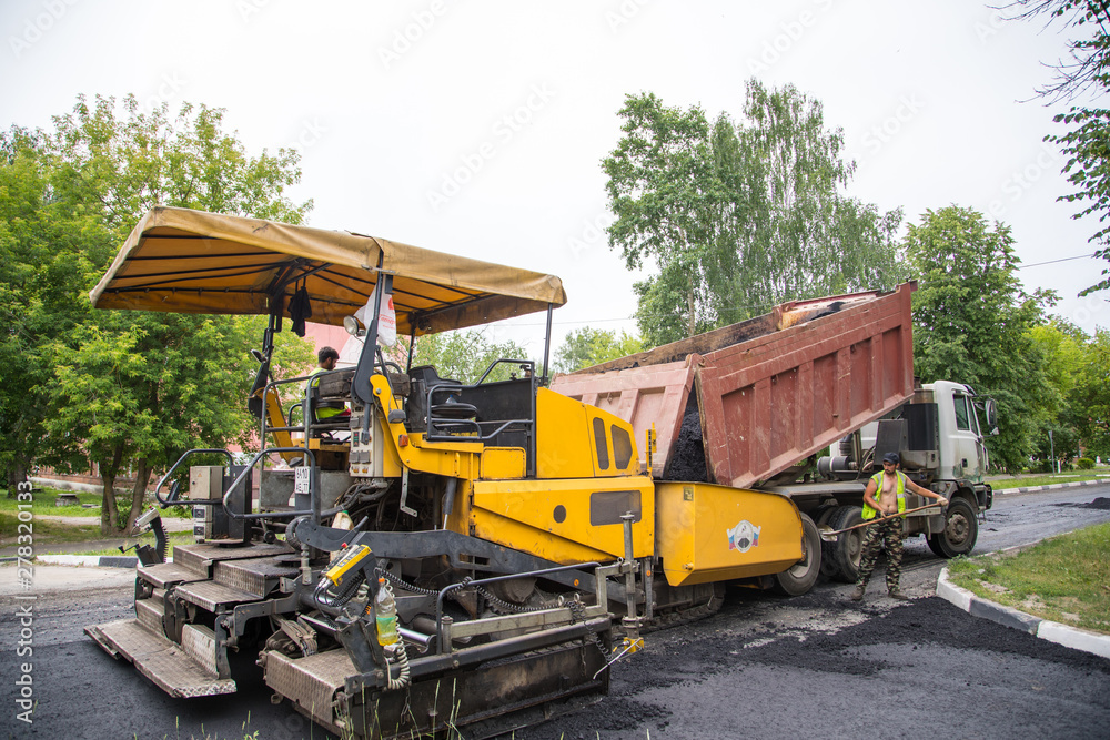 SHATURA, MOSCOW REGION, RUSSIA - JUNE 12, 2019: Repair of roads, highways and sidewalks. Laying of new asphalt pavement.
