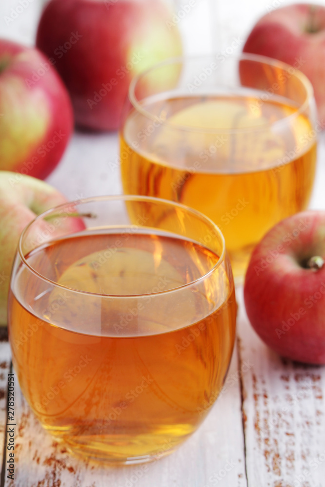 Two glasses with apple juice Two glasses with apple juice