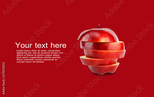 Stack of red apple sliced on red background with copy space and sample text