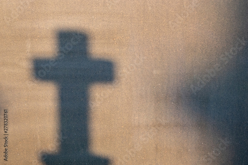 Cemetery reflection on a granite tombstone. The shadow of the crosses and tombstones.