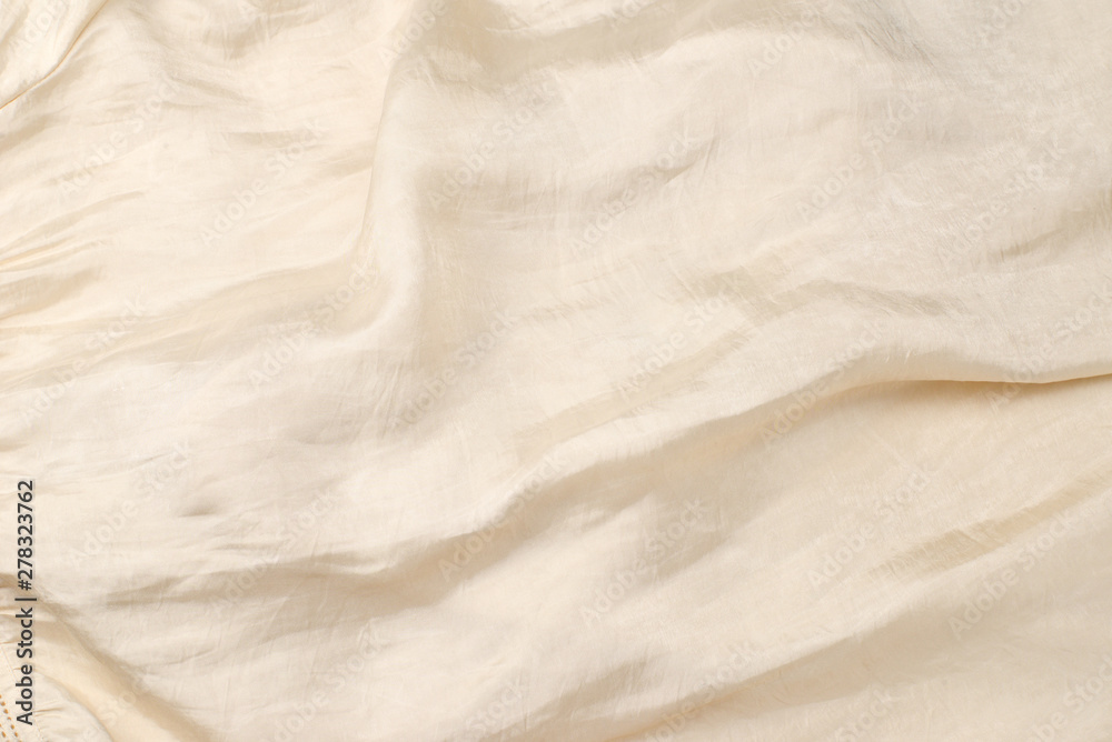Soft smooth beige silk fabric background. Fabric texture. Soft smooth beige silk fabric background. Fabric texture.