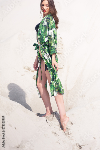 Sexy young woman posing on the sand