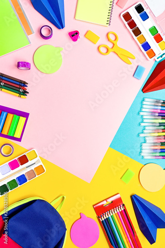 School supplies and lunchbox with food for kids. Colorful stationery layout on multicolor background, copy space