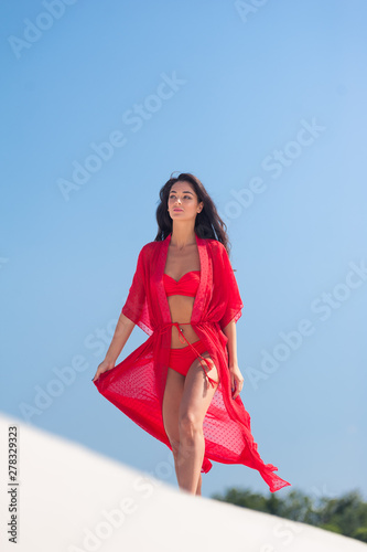 Summer Fashion. Sexy European Woman In Red Swimsuit On Beach