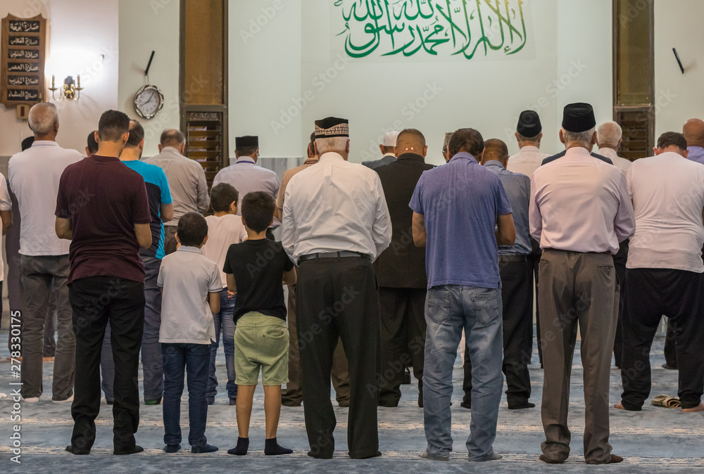 Muslim believers pray in prayer room of the Ahmadiyya Shaykh Mahmud mosque in Haifa city in Israel Muslim believers pray in prayer room of the Ahmadiyya Shaykh Mahmud mosque in Haifa city in Israel