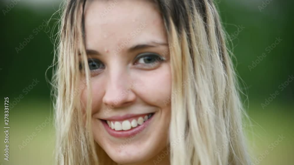 Close-up portrait of a happy attractive Caucasian blonde girl with wet hair during a rain on the nature outdoor on a wheat field. Happiness hope flirting and coquetry Close-up portrait of a happy attractive Caucasian blonde girl with wet hair during a rain on the nature outdoor on a wheat field. Happiness hope flirting and coquetry