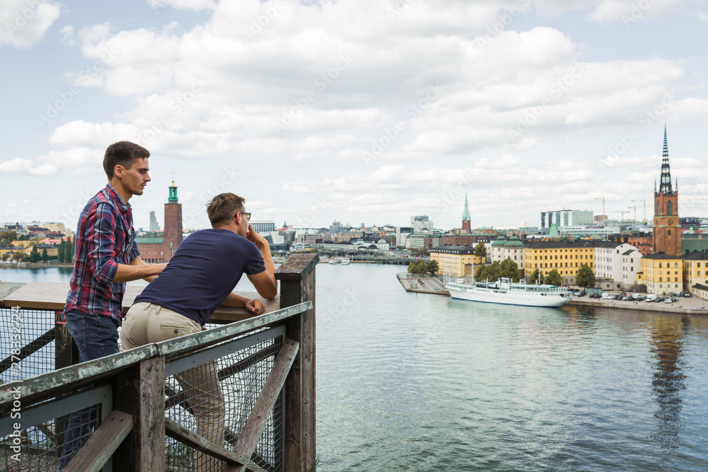 Two young friends looking at the amazing view of the city and sea