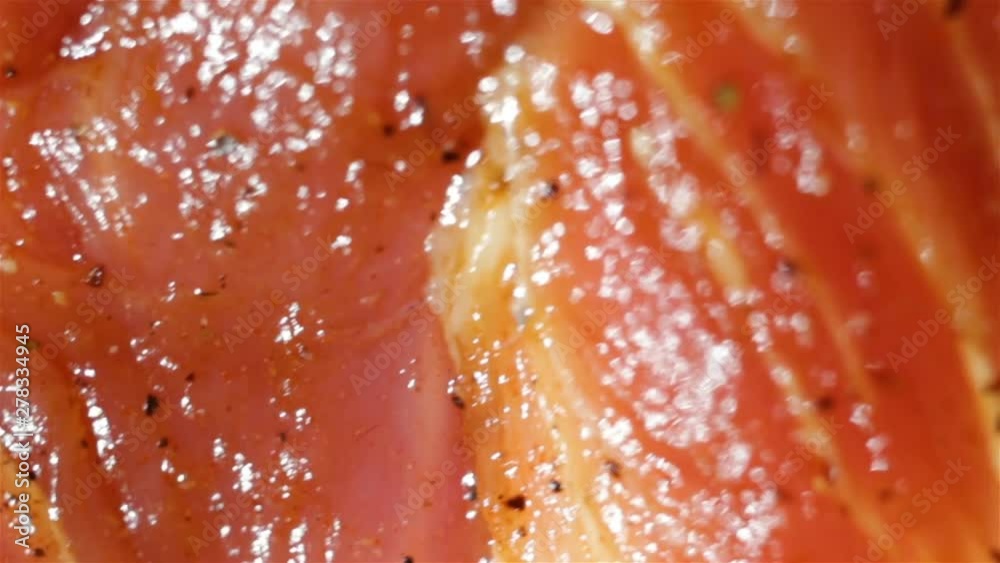 shiny raw piece of fresh meat extremely close-up, soft focus, smooth movement, real time. Marinated in sauce and spices pork has layers of fat. shiny raw piece of fresh meat extremely close-up, soft focus, smooth movement, real time. Marinated in sauce and spices pork has layers of fat.