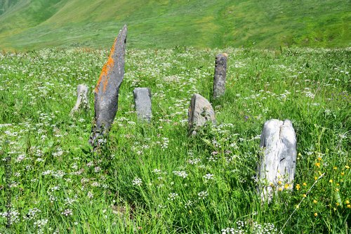 Russia, North Ossetia. Old abandoned cemetery in  upper point of Zrugskoe  gorge near abandoned village of Khozitykau in summer photo