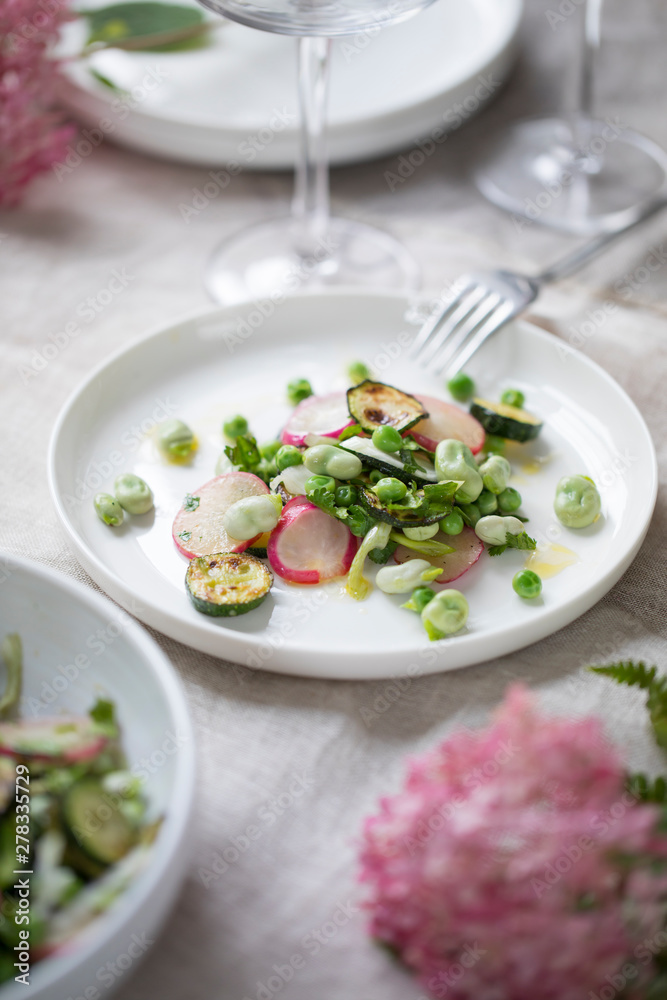 Fresh garden salad with broad beans, green peas, radishes and courgette Fresh garden salad with broad beans, green peas, radishes and courgette