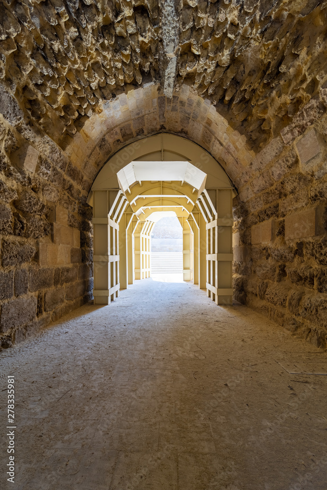 Obraz premium Mamluk era arched stones tunnel leading to Al-Muayyad Bimaristan (ancient hospital), Darb El Labbana district, Cairo, Egypt