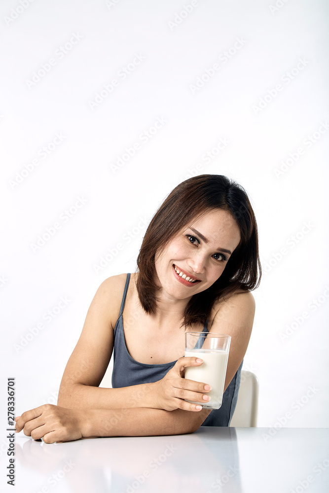 young woman drinking milk on table