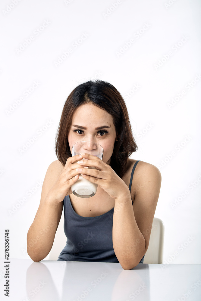 young woman drinking milk on table young woman drinking milk on table