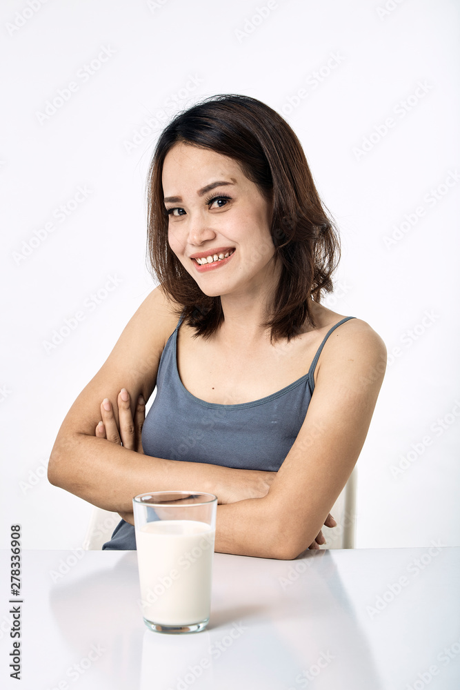 young woman drinking milk on table young woman drinking milk on table