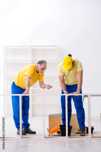 Two contractors carpenters working indoors 