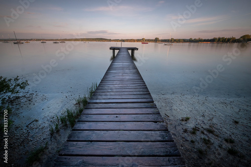 Fototapet a footbridge on a lake in the bavarian area germany