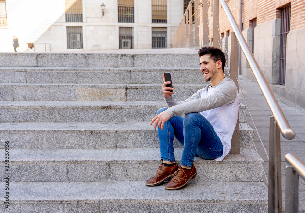 Young attractive happy hipster man talking on smart phone in eur Young attractive happy hipster man talking on smart phone in eur