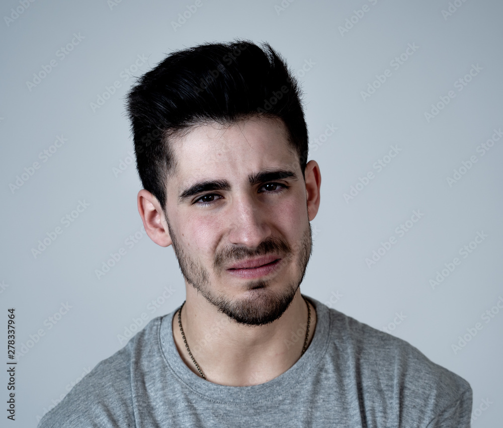 Human expressions and emotions. Portrait of young attractive sad and depressed man Human expressions and emotions. Portrait of young attractive sad and depressed man