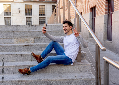 Young attractive man taking selfie while on holidays in European
