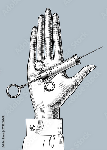 Woman's hand with a retro syringe on her palm