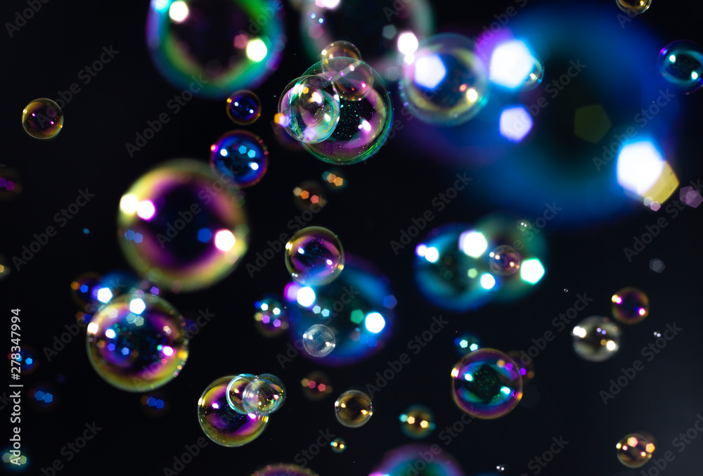 beautiful rainbow colorful of soap bubbles floating on black background. beautiful rainbow colorful of soap bubbles floating on black background.