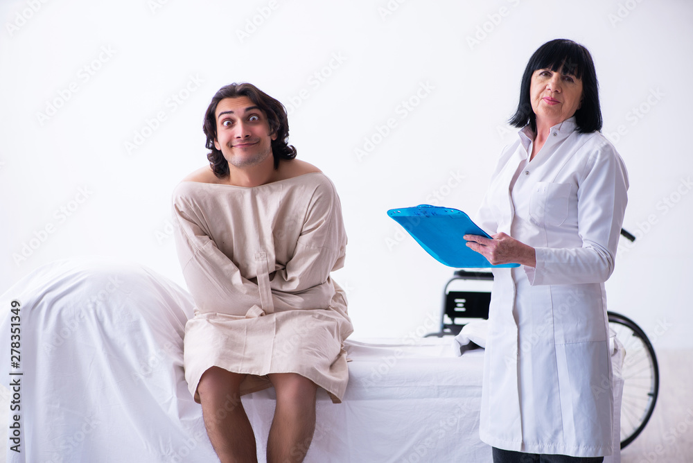 Old female psychiatrist visiting young male patient Old female psychiatrist visiting young male patient