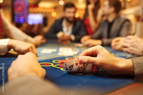 People play poker at the table in the casino. photo