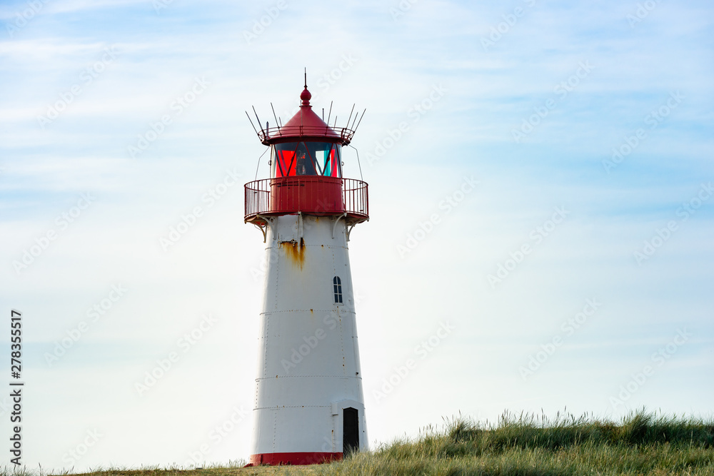 Lighthouse red white on dune.