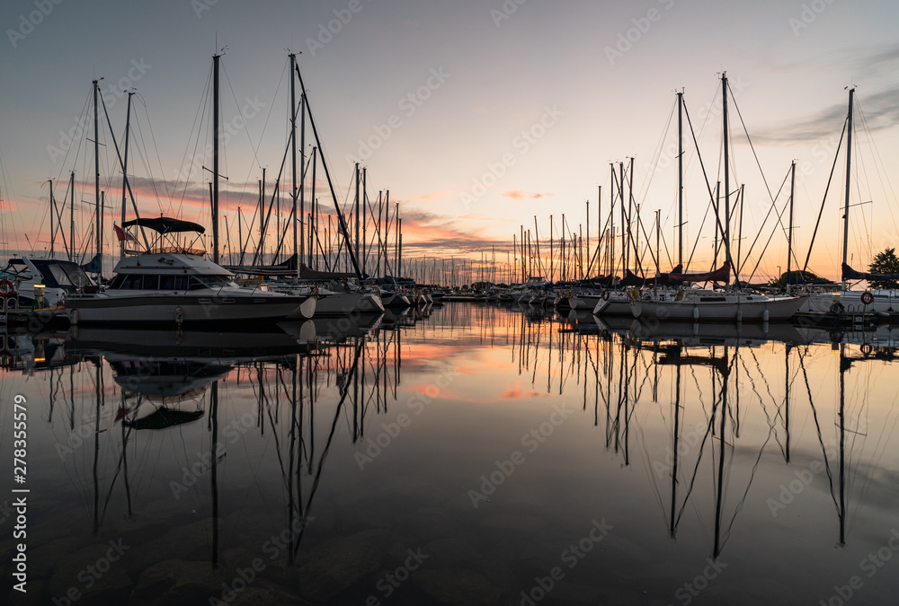 A new day starts as the boats rest during sunrise