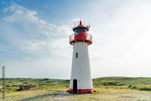 Lighthouse red white on dune.