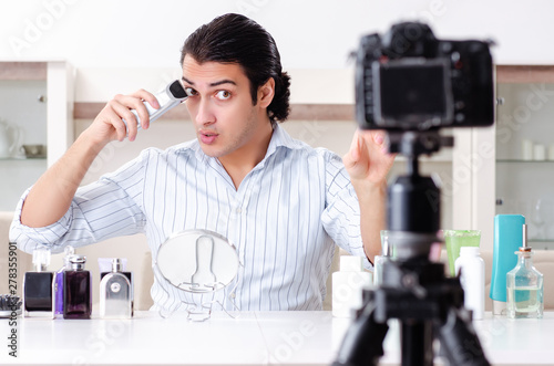 Young handsome man recording his blog in hygiene concept 