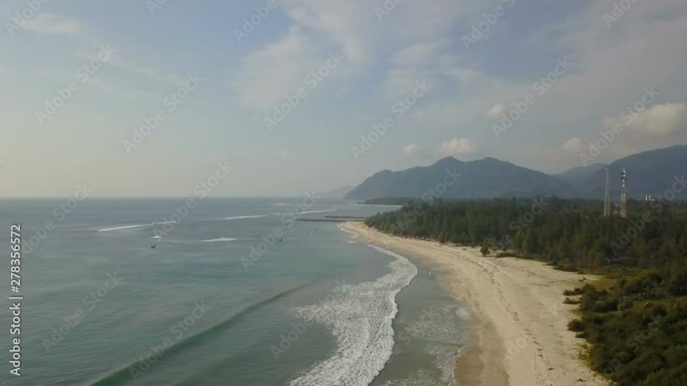 Beautiful tropical beach aerial - a bird's eye view of ocean waves crashing against an empty beach from above Beautiful tropical beach aerial - a bird's eye view of ocean waves crashing against an empty beach from above
