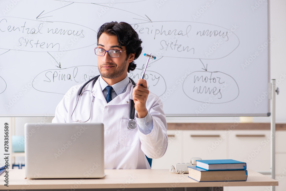 Young male doctor neurologist in front of whiteboard Young male doctor neurologist in front of whiteboard