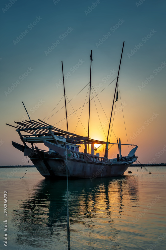 Beautiful Sunrise Boat in seaside with yellow and blue sky background. Dammam -Saudi Arabia
