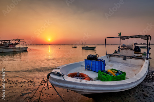 Beautiful Sunrise Boat in seaside with yellow sky background. Dammam -Saudi Arabia photo