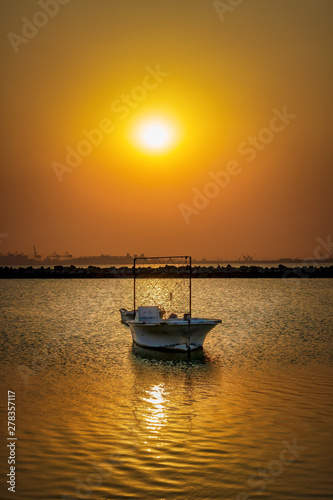 Beautiful Sunrise Boat in seaside with yellow sky. Dammam -Saudi Arabia