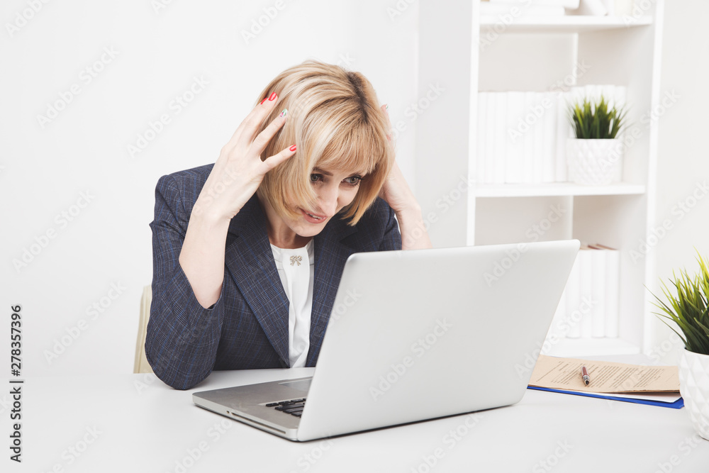 Serious businesswoman surprized in office infront of computer Serious businesswoman surprized in office infront of computer
