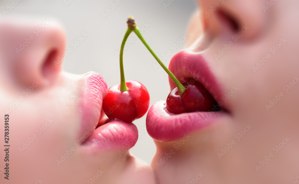 Sweet kiss. Lesbian couple. Female lovers enjoying erotic act with red  cherries. Two young girls lesbians at a party in the club are holding  cocktail cherries. Stock Photo | Adobe Stock