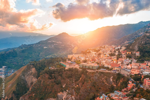 Taormina is a town on the island of Sicily, Italy. Aerial View from above in the evening to temper at the foot of the mountains.