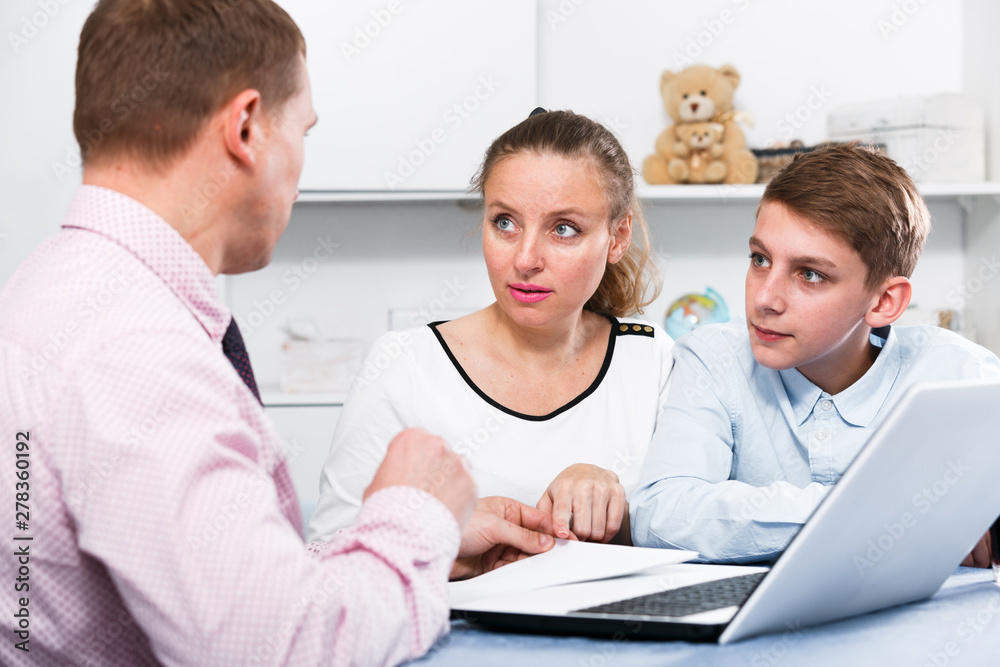 Fototapeta premium Mother and son signing documents