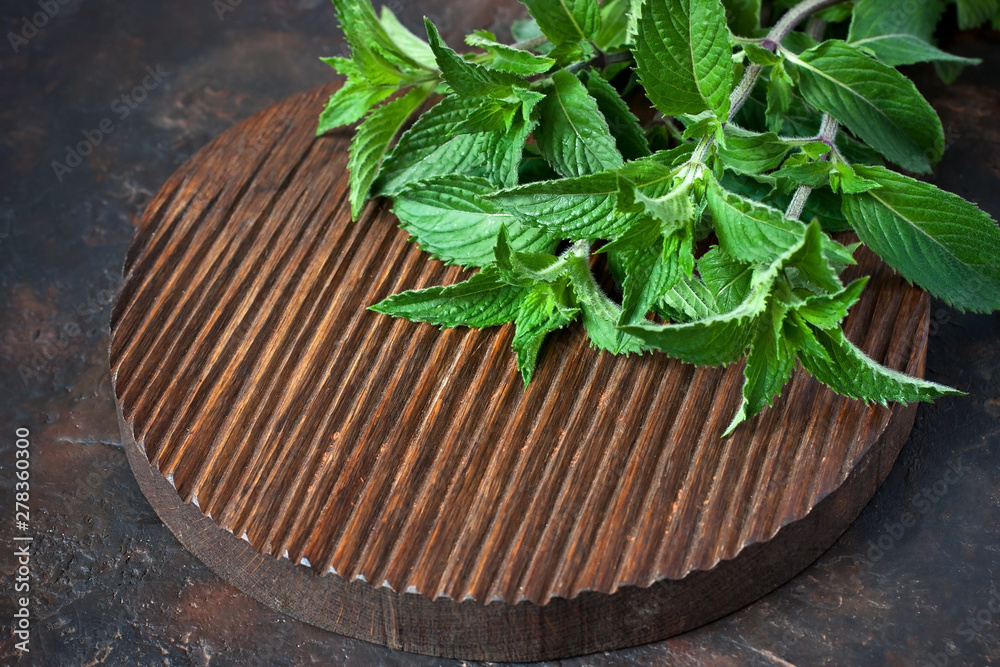 Fresh mint on wooden chopping board Fresh mint on wooden chopping board