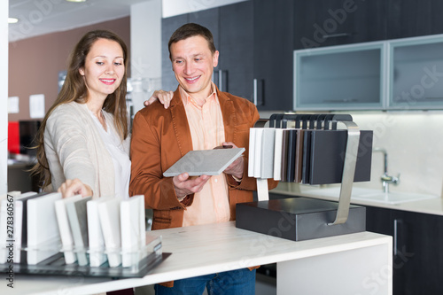 Young couple customers choosing tabletop photo