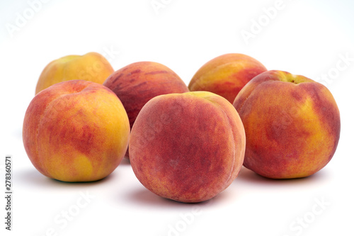 Several peaches isolated on white background.