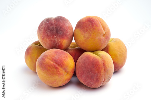Several peaches isolated on white background.