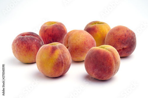 Several peaches isolated on white background.