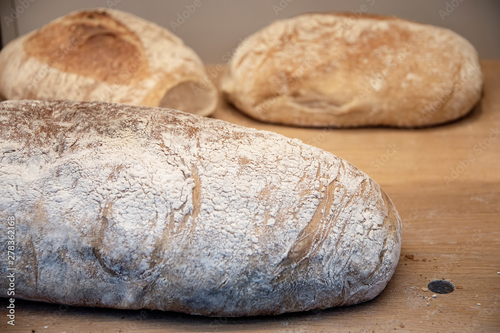 Finland, Helsinki - Jan 2019: loaves of bread cooling on a wooden board