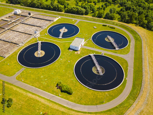Aerial view of sewage treatment plant. Industrial water treatment for big city from drone view. Waste water management.