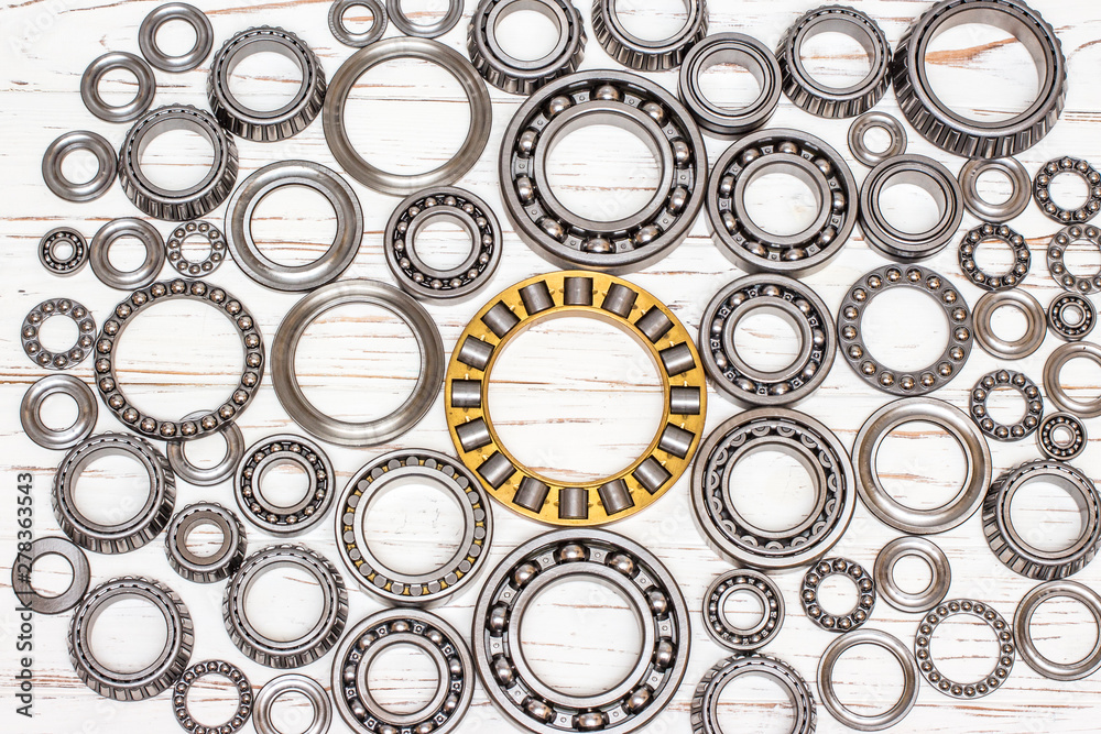 Bearings of all kinds and classifications on a white wooden background. Bearings of all kinds and classifications on a white wooden background.